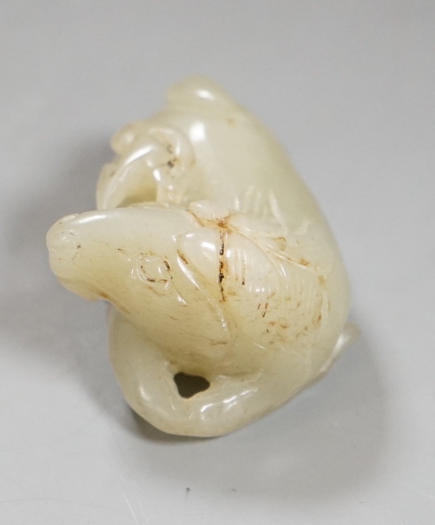 A 19th century Chinese pale celadon jade figure of a seated horse, 6cm wide